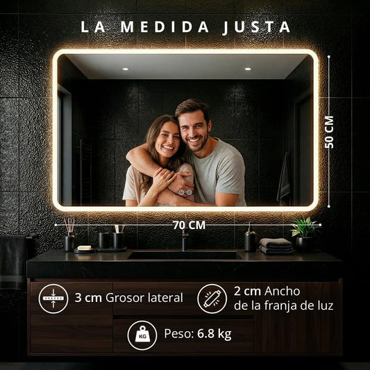 Espejo LED antivaho de 70x50 cm instalado sobre un mueble de doble lavabo en un baño moderno.